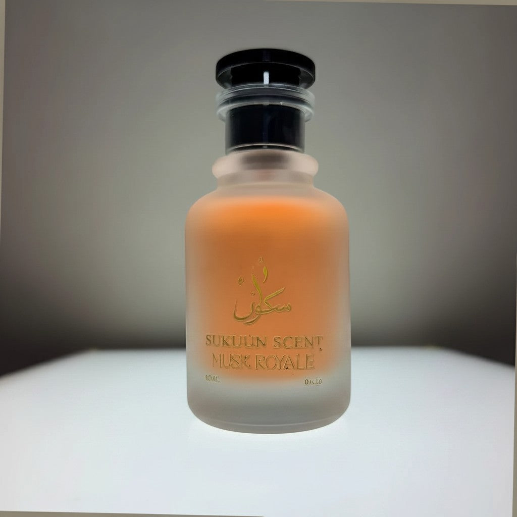 Sukuun Scent Musk Royale 50ML premium Eau de Parfum in a frosted glass bottle with gold lettering, surrounded by white flower petals and cinnamon sticks.