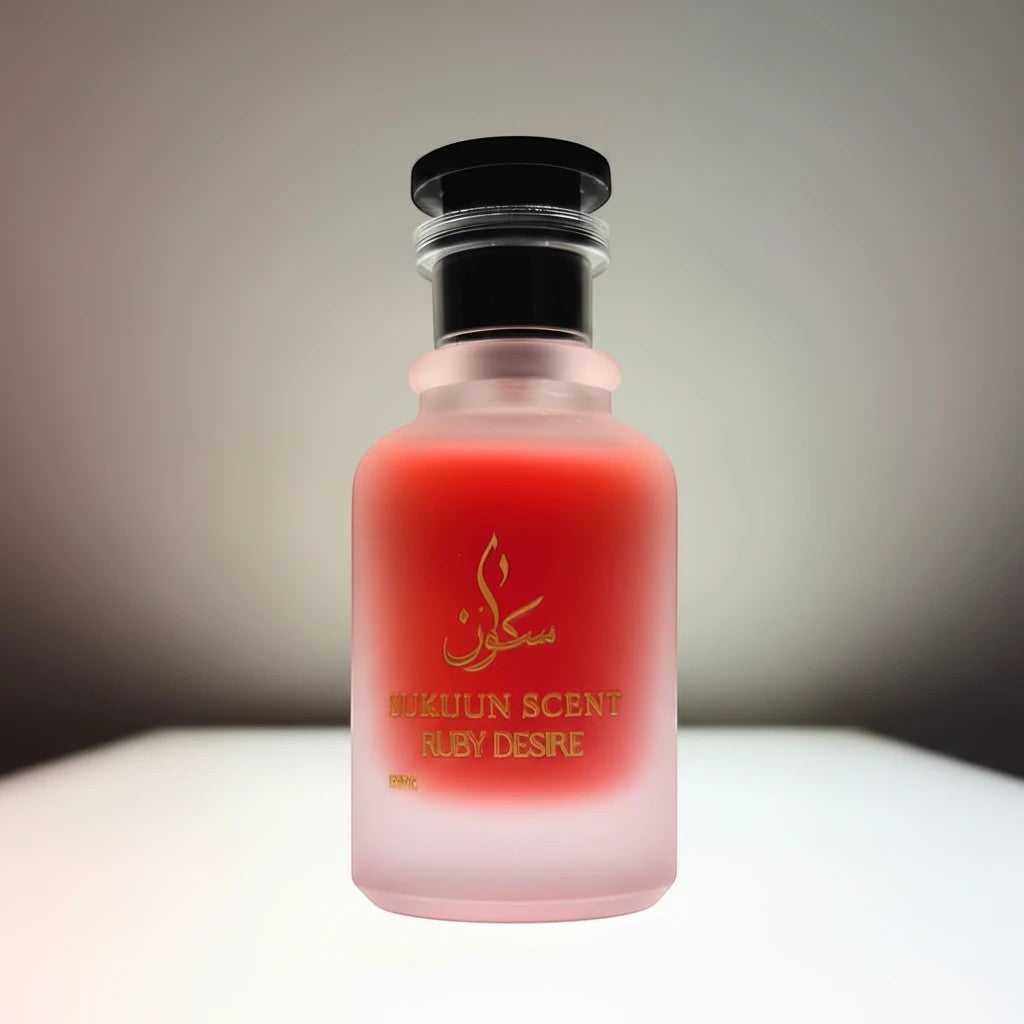 Sukuun Scent Ruby Desire Eau De Parfum in a frosted glass bottle with gold accents and a red hue.