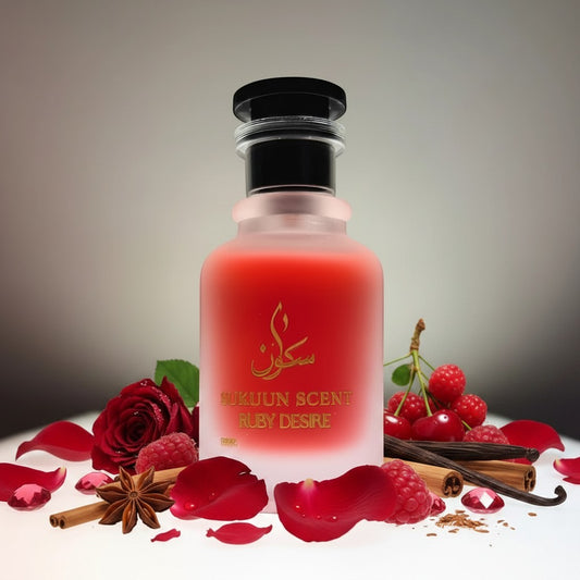 Sukuun Scent Ruby Desire Eau De Parfum in a frosted glass bottle with gold accents and a black cap. The perfume is a vibrant ruby red.